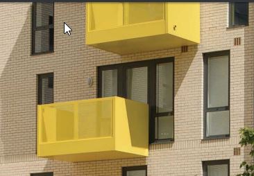 brick building with yellow balconies